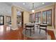 Charming dining room with hardwood floors, plantation shutters, and a view to the living area at 3680 Belvedere Park Ln, Las Vegas, NV 89141