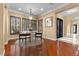 Bright dining room with hardwood floors, plantation shutters, and a modern chandelier at 3680 Belvedere Park Ln, Las Vegas, NV 89141