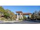 Elegant gated community entrance with stone accents, desert landscaping, and clear blue sky at 3680 Belvedere Park Ln, Las Vegas, NV 89141