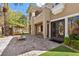 Grand home exterior featuring double doors, a fire pit, and a charming swing set at 3680 Belvedere Park Ln, Las Vegas, NV 89141