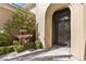 Ornate front entrance with a decorative iron door, stone fountain, and manicured greenery enhancing curb appeal at 3680 Belvedere Park Ln, Las Vegas, NV 89141