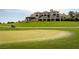 Golf course view featuring a putting green in foreground and luxury home in the background at 3680 Belvedere Park Ln, Las Vegas, NV 89141