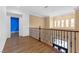 Hallway featuring wood floors and decorative wrought iron railing at 3680 Belvedere Park Ln, Las Vegas, NV 89141