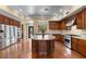 Gourmet kitchen featuring stainless steel appliances, custom cabinetry, and a center island at 3680 Belvedere Park Ln, Las Vegas, NV 89141