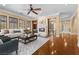 Cozy living area with hardwood floors, a fireplace, built-in shelves, and an open view to the dining area at 3680 Belvedere Park Ln, Las Vegas, NV 89141