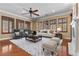 Comfortable living room featuring hardwood floors, plantation shutters, plush seating, and a ceiling fan at 3680 Belvedere Park Ln, Las Vegas, NV 89141