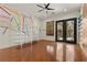 Playroom featuring unique wall decor, custom shelving, and double doors leading to the outside at 3680 Belvedere Park Ln, Las Vegas, NV 89141