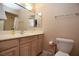 Bathroom featuring a vanity with a sink, mirror, and toilet at 3905 E Cherokee Ave, Las Vegas, NV 89121