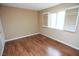 This bedroom has wood floors, a window with shutters, and neutral paint at 3905 E Cherokee Ave, Las Vegas, NV 89121
