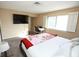 Calm bedroom with tv, adjacent desk, and a naturally lit window with white shutters at 3905 E Cherokee Ave, Las Vegas, NV 89121
