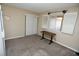 Cozy bedroom featuring carpeted floors, a window with white shutters, and a small desk for studying at 3905 E Cherokee Ave, Las Vegas, NV 89121