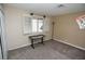 Cozy bedroom with a window, desk, and carpet at 3905 E Cherokee Ave, Las Vegas, NV 89121