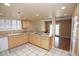 Bright kitchen featuring a built-in cooktop, wooden cabinets, and a tiled floor with room to entertain at 3905 E Cherokee Ave, Las Vegas, NV 89121