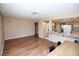 Open-concept living room and kitchen with wood floors and neutral paint at 3905 E Cherokee Ave, Las Vegas, NV 89121