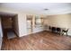 Spacious living area with wood floors leading to a dining area with neutral paint at 3905 E Cherokee Ave, Las Vegas, NV 89121