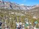 Scenic aerial view of cabin nestled among the trees with a beautiful mountain backdrop at 4165 Mont Blanc Way, Mount Charleston, NV 89124