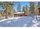 Charming cabin exterior featuring a wooden deck and snow-covered yard at 4165 Mont Blanc Way, Mount Charleston, NV 89124