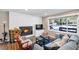 Warm living room featuring a modern fireplace, plush sofa, and views of a winter landscape at 4165 Mont Blanc Way, Mount Charleston, NV 89124