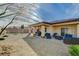 Relaxing backyard with covered patio, comfortable seating, and desert landscaping at 4459 S Glory Vine Ln, Pahrump, NV 89061