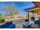 Backyard featuring a covered patio with outdoor furniture, desert landscaping and brick walls at 4459 S Glory Vine Ln, Pahrump, NV 89061
