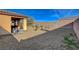 Low maintenance backyard with desert landscaping, covered patio, and privacy walls at 4459 S Glory Vine Ln, Pahrump, NV 89061