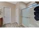 Bathroom with a shower featuring glass door with decorative towels and a double doors leading to the bedroom at 4459 S Glory Vine Ln, Pahrump, NV 89061