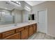 A Primary bathroom features a dual sink vanity with framed mirrors, tile floors, and a glass shower at 4459 S Glory Vine Ln, Pahrump, NV 89061