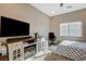 Bedroom featuring an entertainment center, a modern ceiling fan, and a comfortable bed at 4459 S Glory Vine Ln, Pahrump, NV 89061