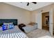 Bedroom with two beds featuring sports accents, soft carpet, and an open door at 4459 S Glory Vine Ln, Pahrump, NV 89061