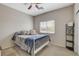 Carpeted bedroom showing a window, a ceiling fan, and a white metal bedframe at 4459 S Glory Vine Ln, Pahrump, NV 89061