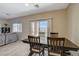 Bright and airy dining area features a large window and sliding door, creating an inviting space for meals at 4459 S Glory Vine Ln, Pahrump, NV 89061