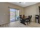 Cozy dining area with dark wood table and chairs, sliding glass doors offer access to a fenced backyard at 4459 S Glory Vine Ln, Pahrump, NV 89061