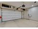 Spacious garage with epoxy flooring, built-in shelves, and garage door opener at 4459 S Glory Vine Ln, Pahrump, NV 89061