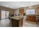 Spacious kitchen featuring granite countertops, stainless steel appliances, and island with seating, flows into dining area at 4459 S Glory Vine Ln, Pahrump, NV 89061