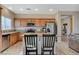 Open concept kitchen with granite countertops, stainless appliances and breakfast bar overlooks the living area at 4459 S Glory Vine Ln, Pahrump, NV 89061