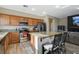 Bright kitchen features stainless steel appliances, granite countertops, and a breakfast bar, next to the Gathering room at 4459 S Glory Vine Ln, Pahrump, NV 89061