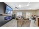 Spacious living room featuring a modern electric fireplace, a large TV, comfortable seating, and lots of natural light at 4459 S Glory Vine Ln, Pahrump, NV 89061