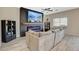Comfortable living room with a cozy sofa, modern fireplace, built-in shelving, and a large flat-screen television at 4459 S Glory Vine Ln, Pahrump, NV 89061