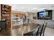 Inviting living space showcasing a large dining table adjacent to a modern kitchen and comfortable living area at 4459 S Glory Vine Ln, Pahrump, NV 89061