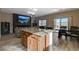 Open-concept kitchen, dining, and living area featuring modern appliances and a seamless flow for entertaining at 4459 S Glory Vine Ln, Pahrump, NV 89061