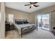 This bedroom features carpet flooring, a ceiling fan, and a sliding glass door for lots of natural light at 4459 S Glory Vine Ln, Pahrump, NV 89061