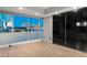 Light bedroom showcasing floor to ceiling windows with a city view and sleek, dark closet doors at 4525 Dean Martin Dr # 511, Las Vegas, NV 89103