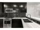 Close-up of kitchen boasting stainless appliances, gray backsplash and marble counter at 4525 Dean Martin Dr # 511, Las Vegas, NV 89103