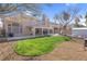 Spacious backyard with a covered patio, grassy lawn, and tidy gravel landscaping at 4647 Stearman Dr, North Las Vegas, NV 89031
