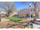 Landscaped backyard featuring a covered patio, grass lawn, and rock garden at 4647 Stearman Dr, North Las Vegas, NV 89031