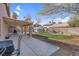 Large backyard featuring covered patio, shed, grass lawn, and privacy wall at 4647 Stearman Dr, North Las Vegas, NV 89031