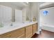 Bathroom featuring double sinks, vanity, hardwood floors and decorative mirror at 4647 Stearman Dr, North Las Vegas, NV 89031