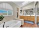 Bright bathroom features a large soaking tub, vanity, and large window at 4647 Stearman Dr, North Las Vegas, NV 89031