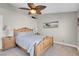 Bedroom with light colored walls features a fan and art at 4647 Stearman Dr, North Las Vegas, NV 89031