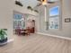 Open-concept dining area with high ceilings, wood floors, large windows, and elegant furnishings at 4647 Stearman Dr, North Las Vegas, NV 89031